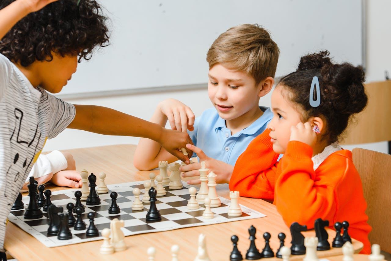 Group of diverse children engaged in a chess game, enhancing strategy skills.